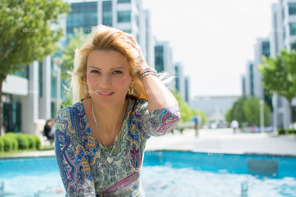 Beautiful young woman near the pool