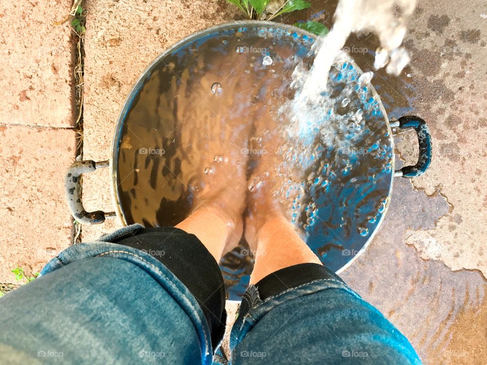 From where I stand in metal bucket Pail full of water, tap faucet running water 