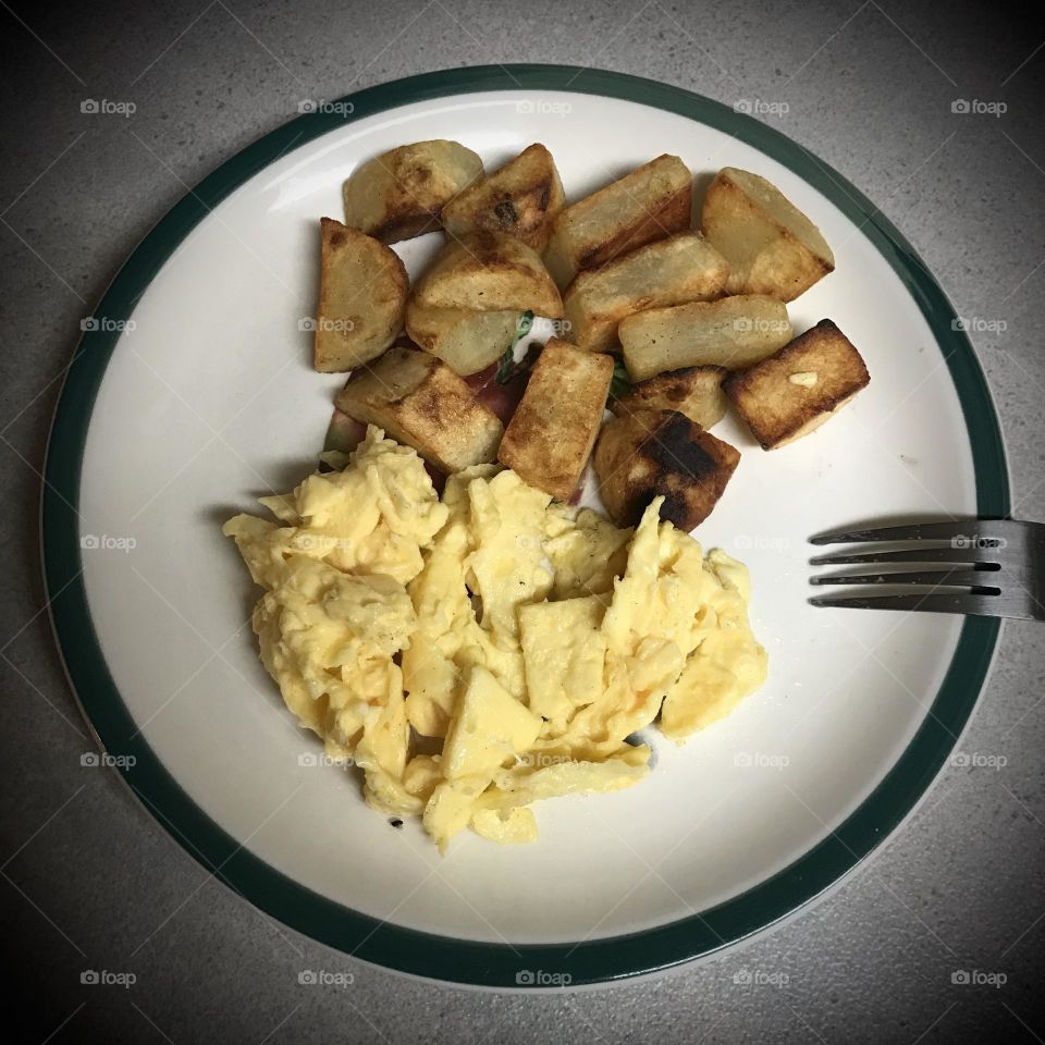 Scrambled eggs and potato as a morning meal. It is simple yet delightful.