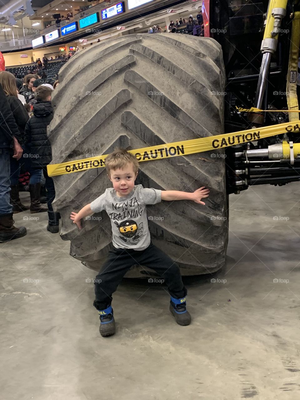 Child by monster truck tire 