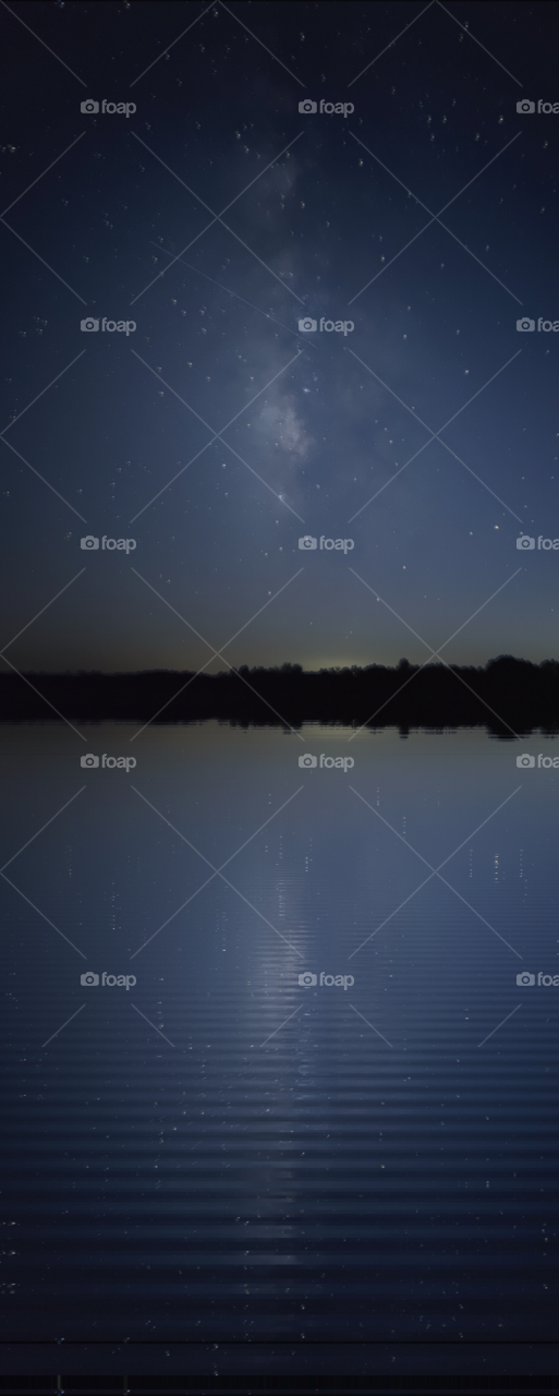 The Milky Way reflection with emphasis placed on the highlighting in the water surface.