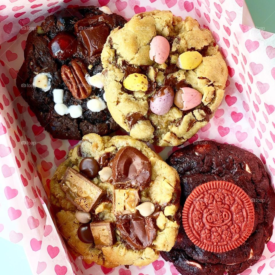 Freshly baked Gooey Easter cookies in chocolate in big chunk with hot tea for afternoon snack in flatlay 