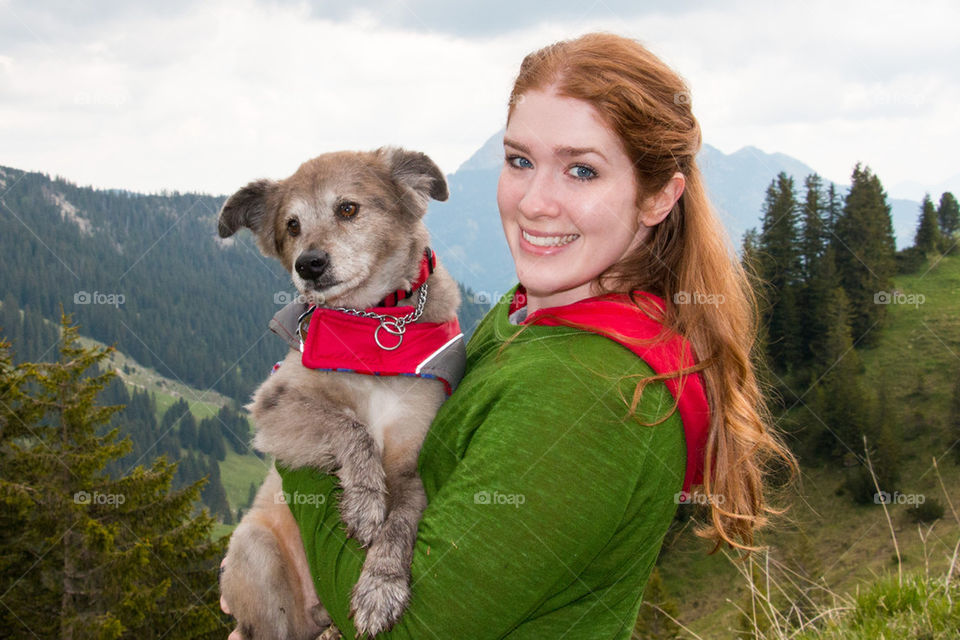Woman and her dog in the alps