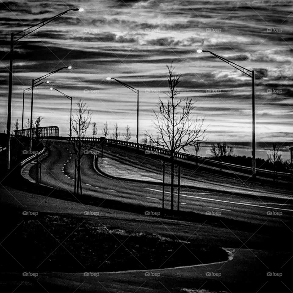 sunrise highway black & white clouds street