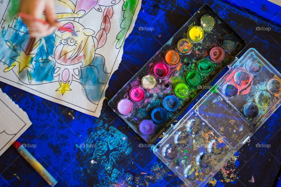 Colorful image of paint and girl painting a princess. Color definitely wins in this image showing such variety of color we have available for us to enjoy!