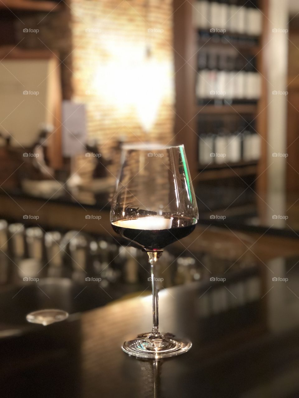 A glass of red wine in snd on a wine bar. Ambiance 