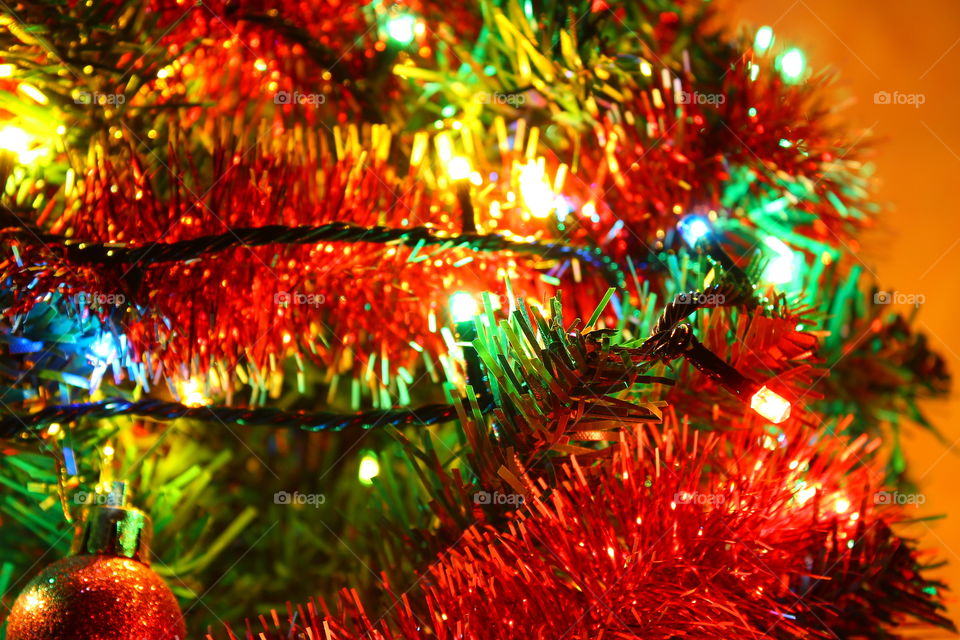 Macro shot of Christmas tree decorations and vivid lights