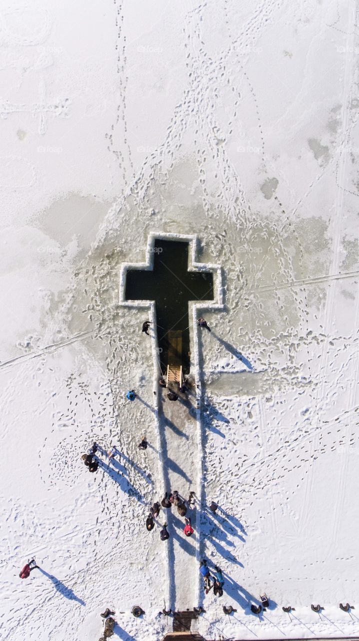 Cross in the frozen river.  Epiphany Holiday