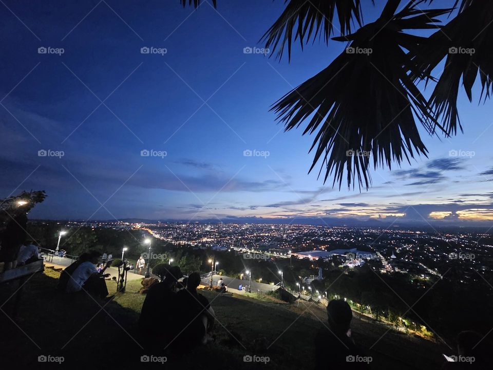 People watched sunset and city light at night on the top of mountain. It's landscape for watching sunset and do many activities.
