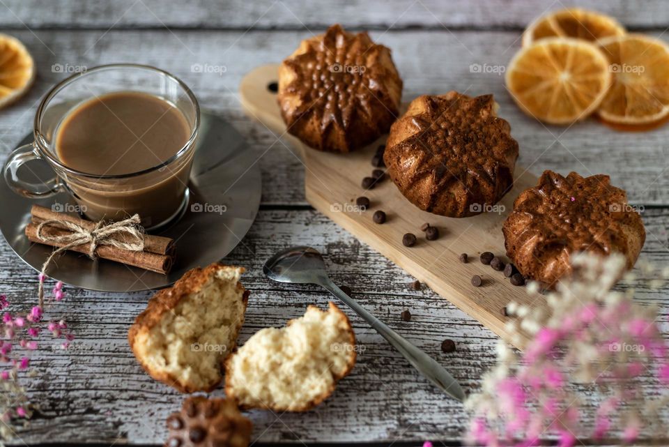 Food still life homemade muffins cookies and coffee latte on blue wooden background