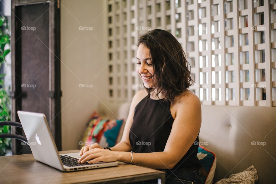 Young Mexican-American entrepreneur and digital nomad Andrea manages her huarache shoe business from Madrid in a co-working space.