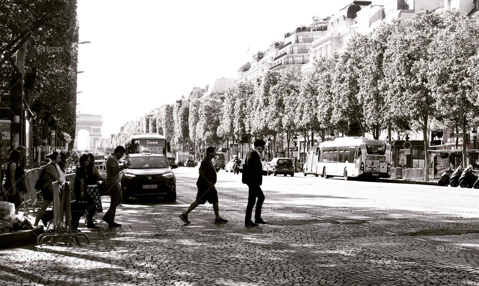 pedestrians crossing the Avenue des Champs-Élysées. Paris, France