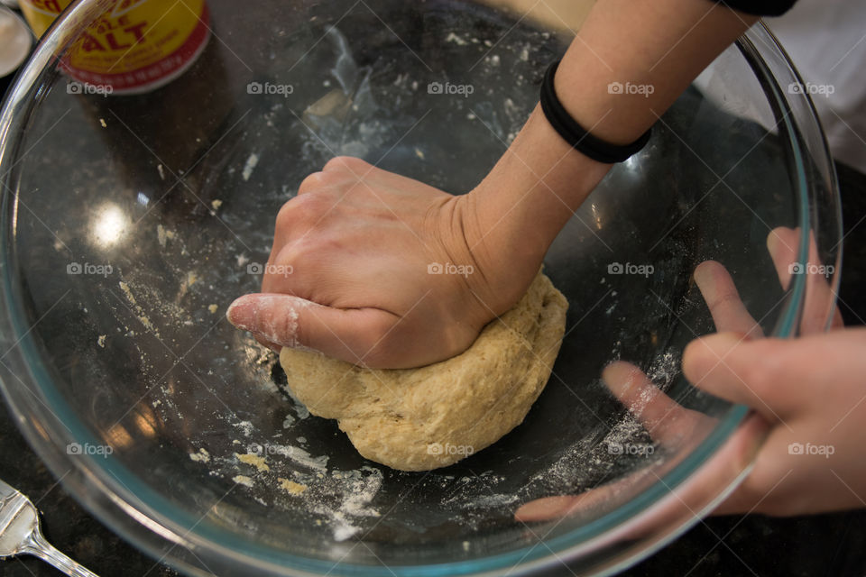 A woman is in the kitchen baking and cooking homemade scones with fruit and fresh herbs