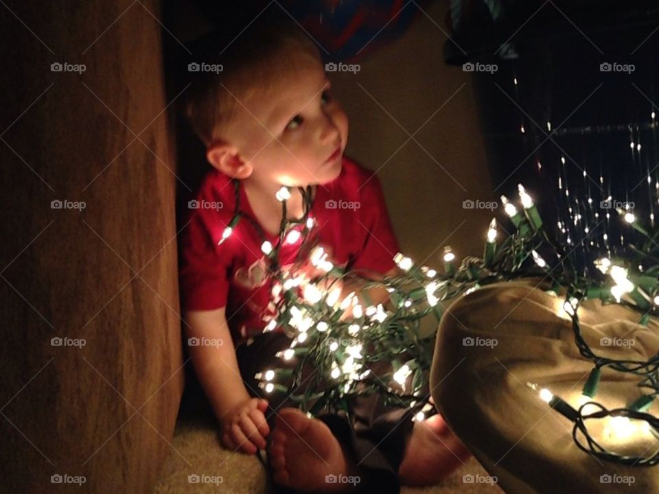 Baby boy and Christmas lights 