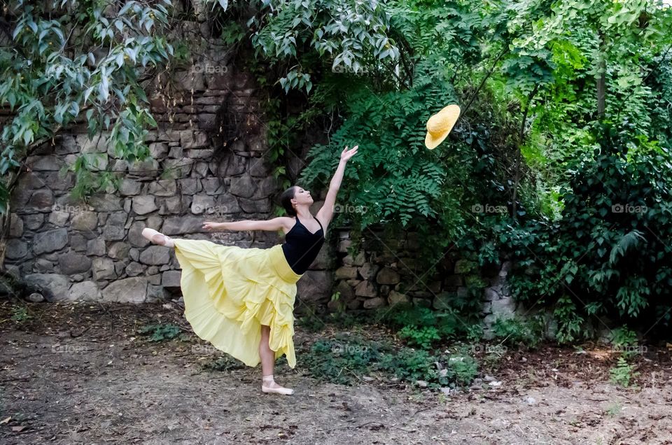 Young Female Ballerina Dancing Outside in Nature