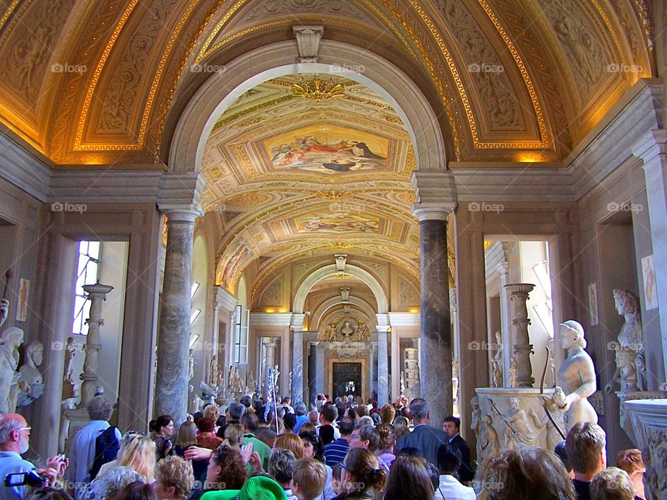 Tourists admiring the ceiling of the Vatican Museum in Rome, Italy