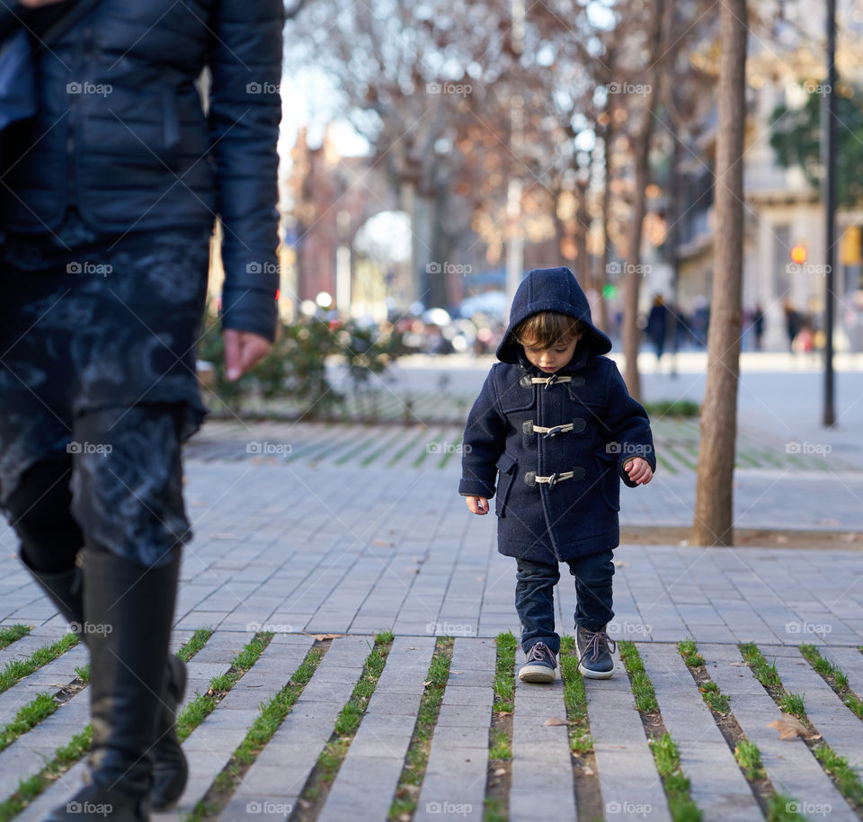 Close-up of boy walking on street