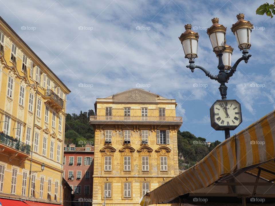 View of buildings and ornate lamppost on the Cours Saleya in the old town of Nice, France.