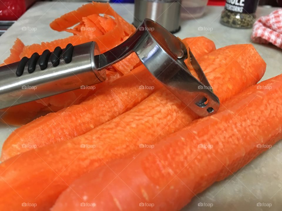 Peeling carrots, food prep in what's cooking 