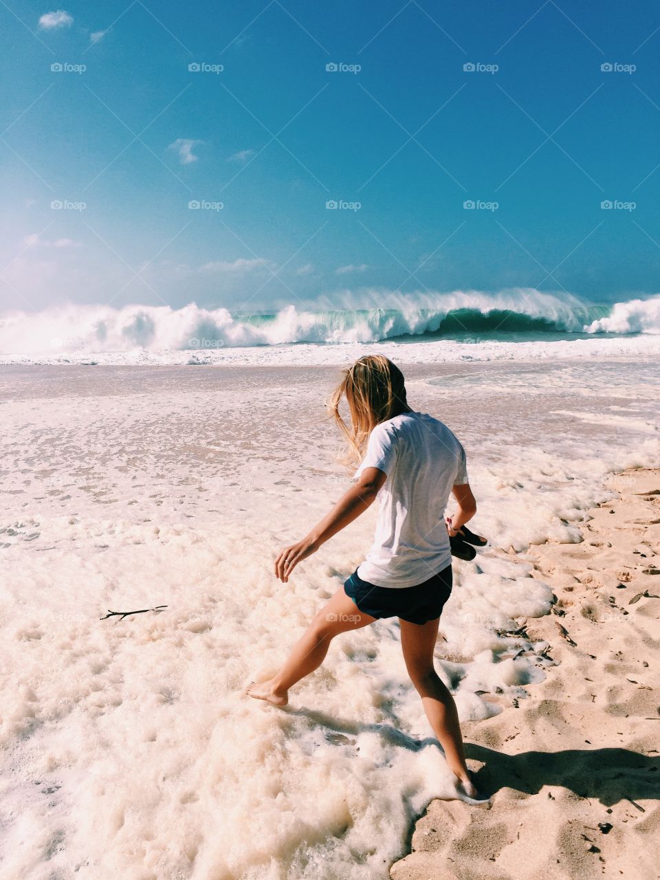 Rear view of a woman walking on beach