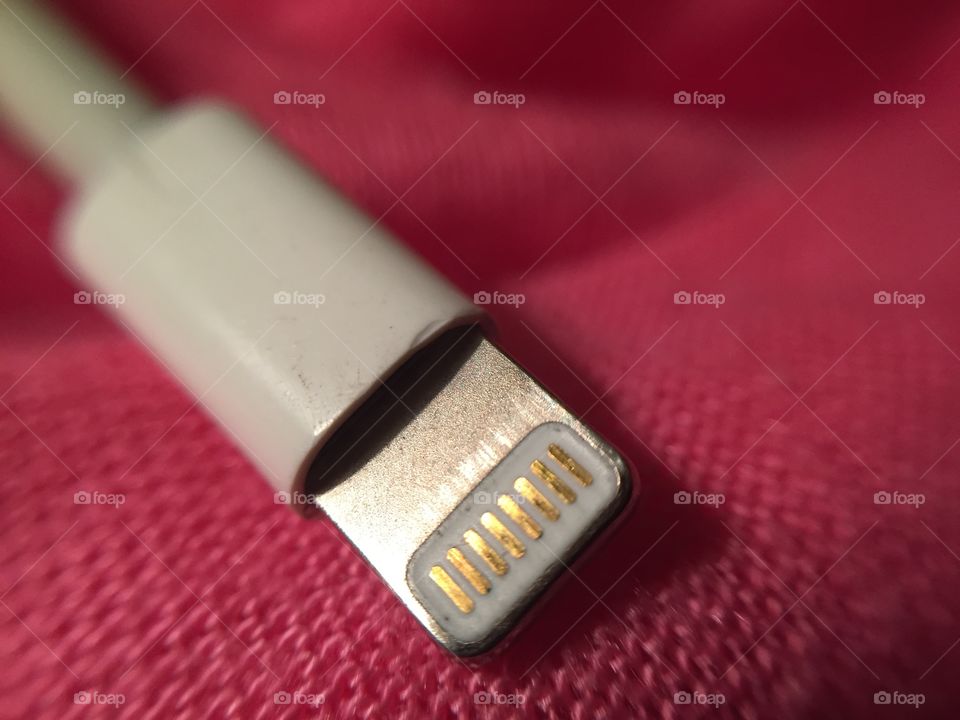 A macro view of the connection on an iPhone charging cable