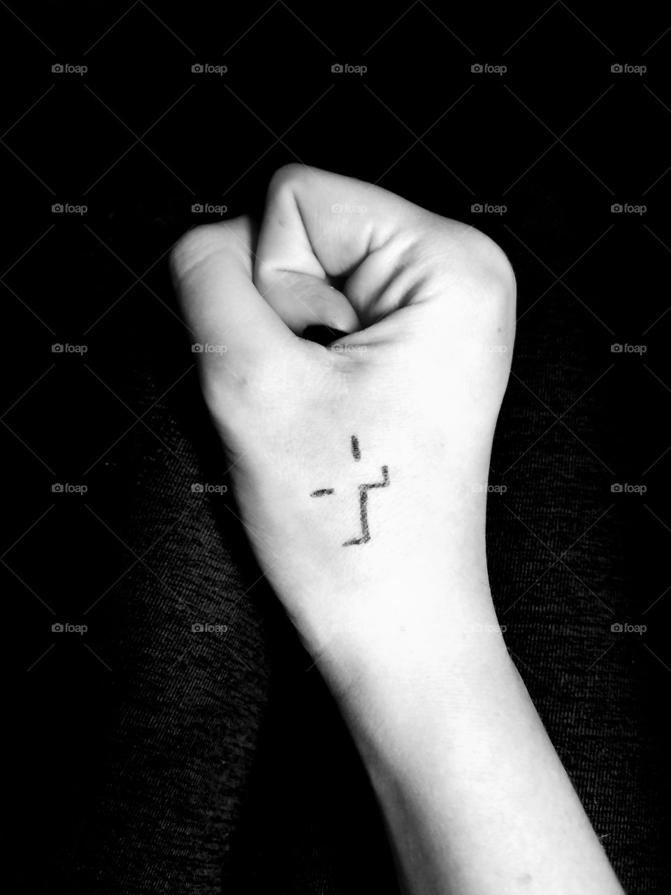 Cross tattoo on hand, black and white