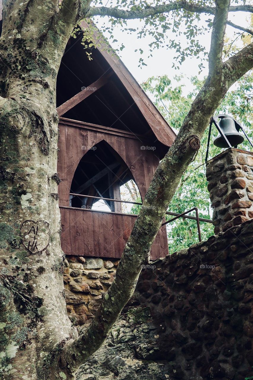 A view up at a small chapel reveals a carved message of love.