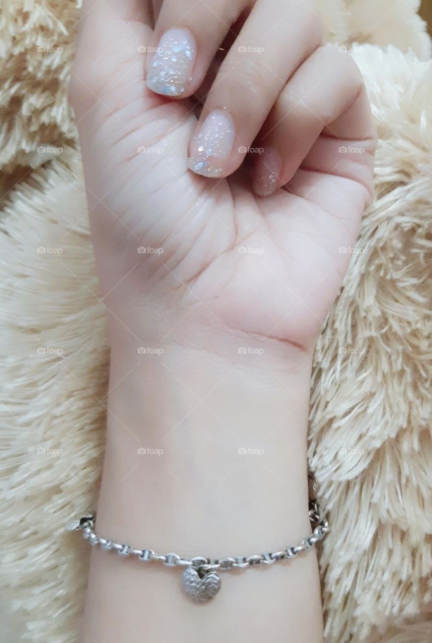White gold bracelet on the hand of a girl