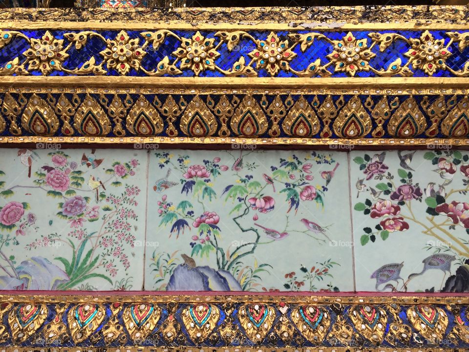 Bangkok, Thailand: SE Asian art tiles with gold, intricate and jeweled mosaic wall at the Grand Palace in Bangkok 