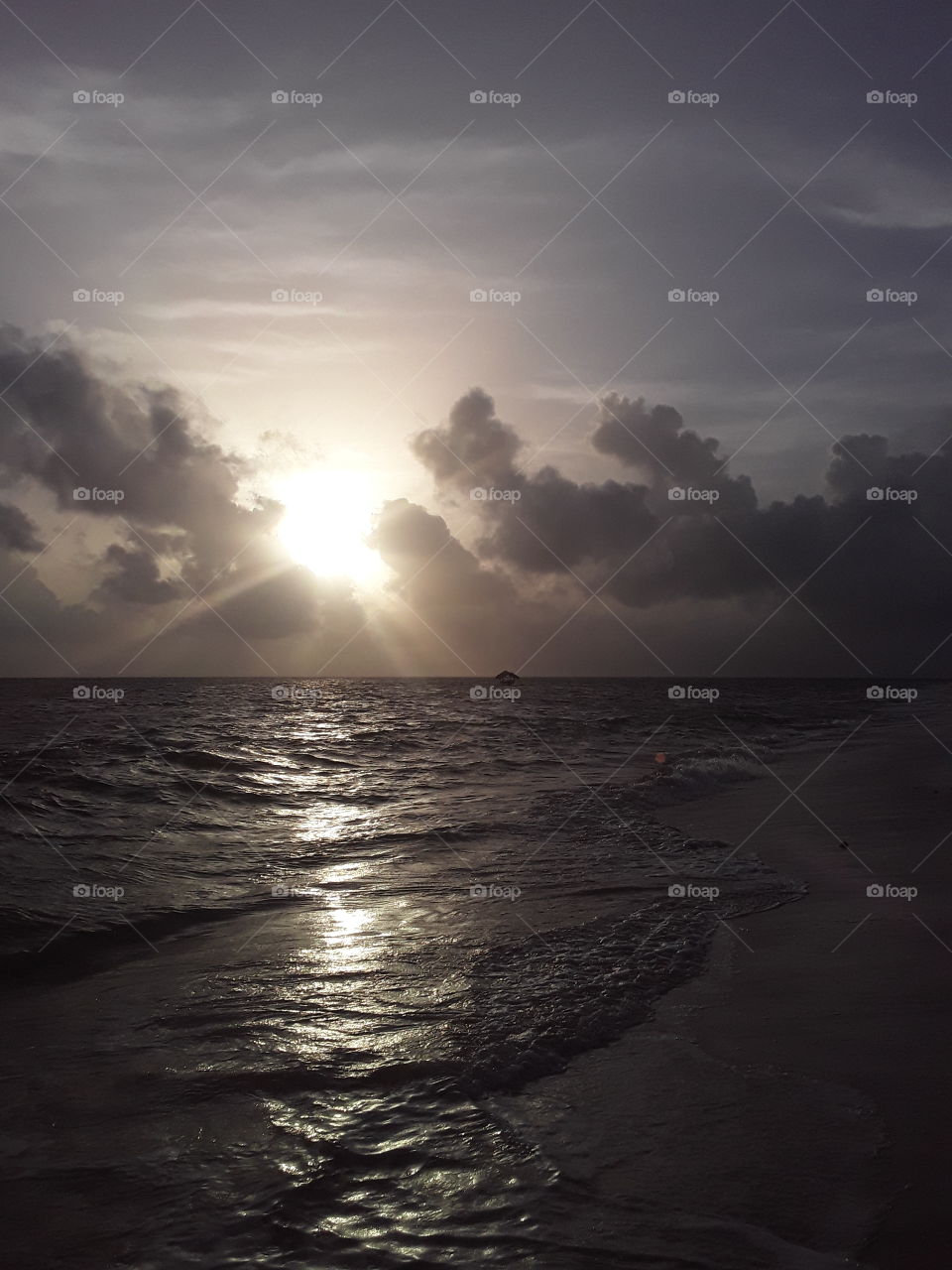 dawn in the tropics. very beautiful colors of the new day. a small boat in the spacious waters of the ocean looks as helpless as a newcomer to freelancing.