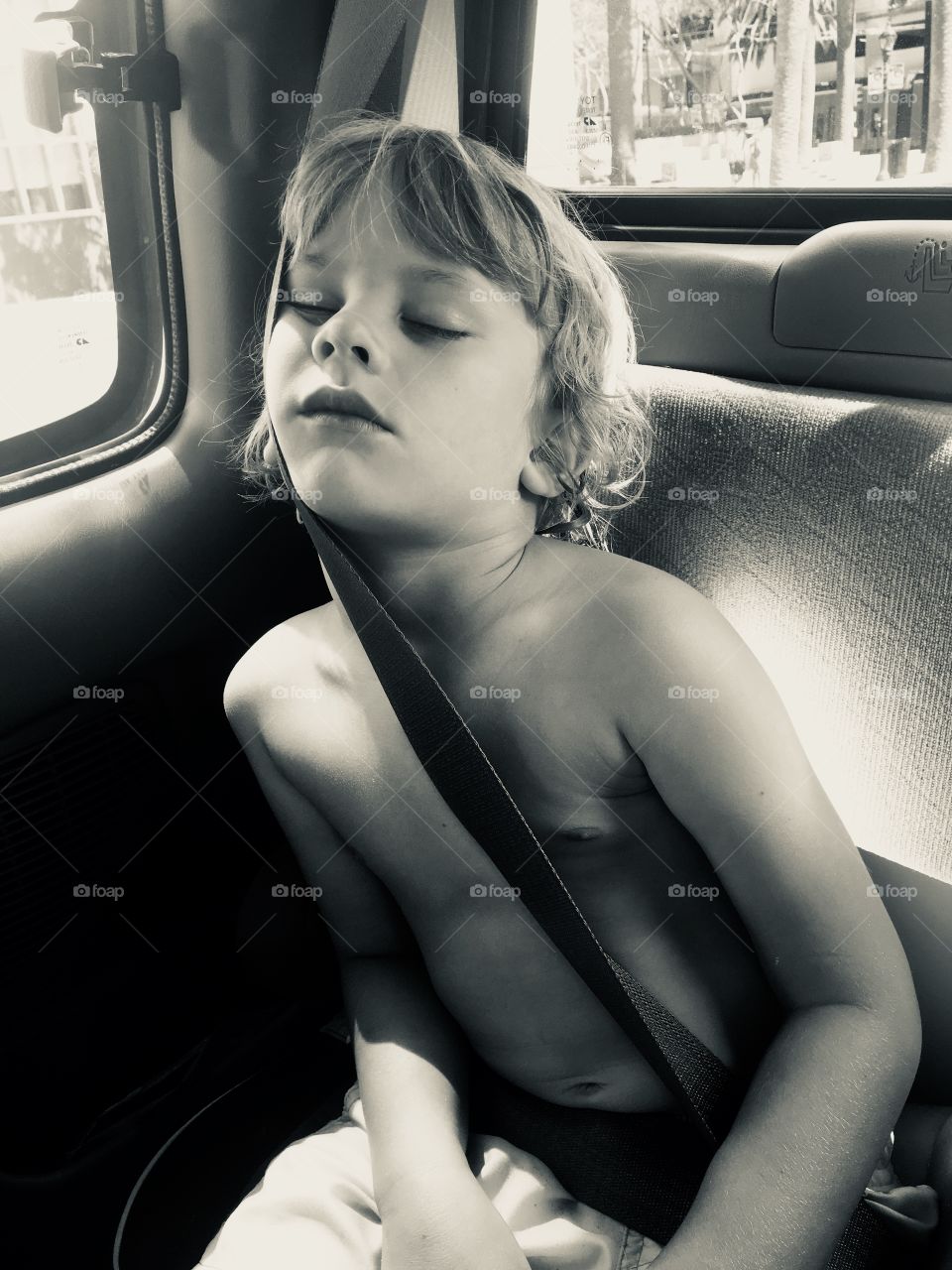 Child sleeps in backseat of truck