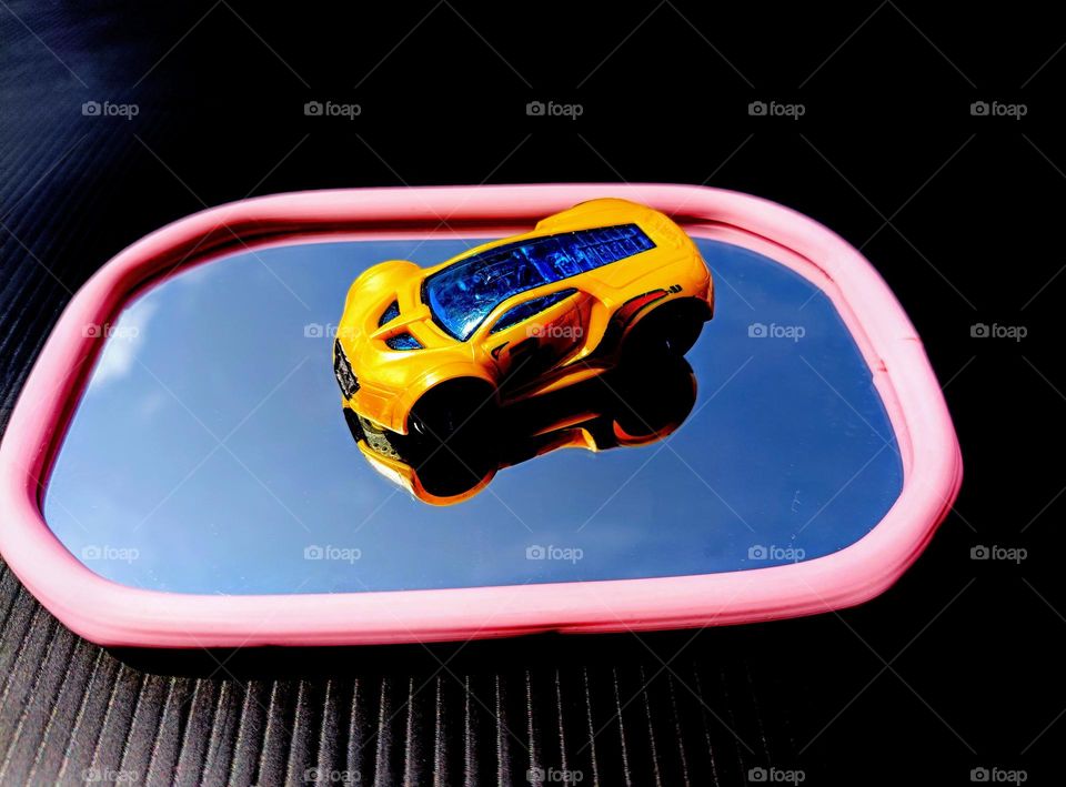 A toy car on the mirror.