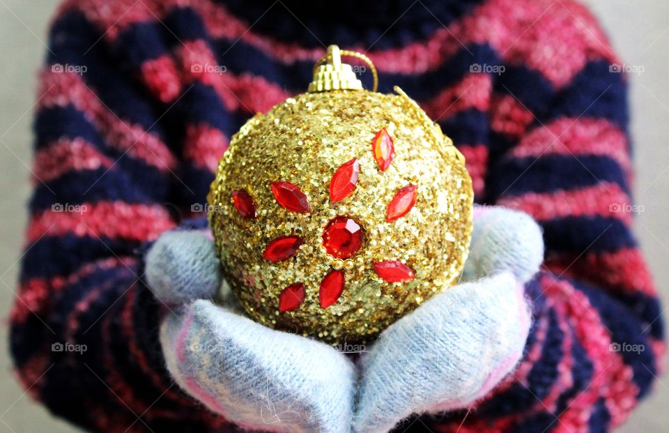 Toy for christmas tree in the hands.