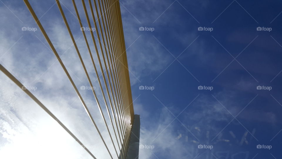 The support beams of the Sunshine Skyway Bridge reach high into a cloudy sky.