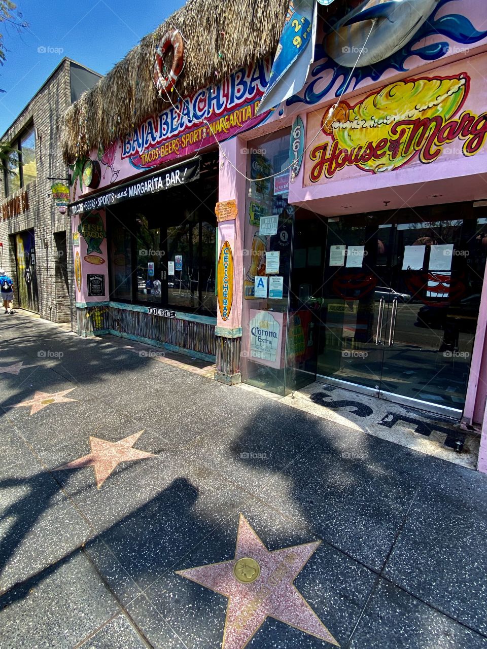 Walking in front of the Baja Beach Bar at Hollywood Boulevard in Hollywood/Los Angeles California 