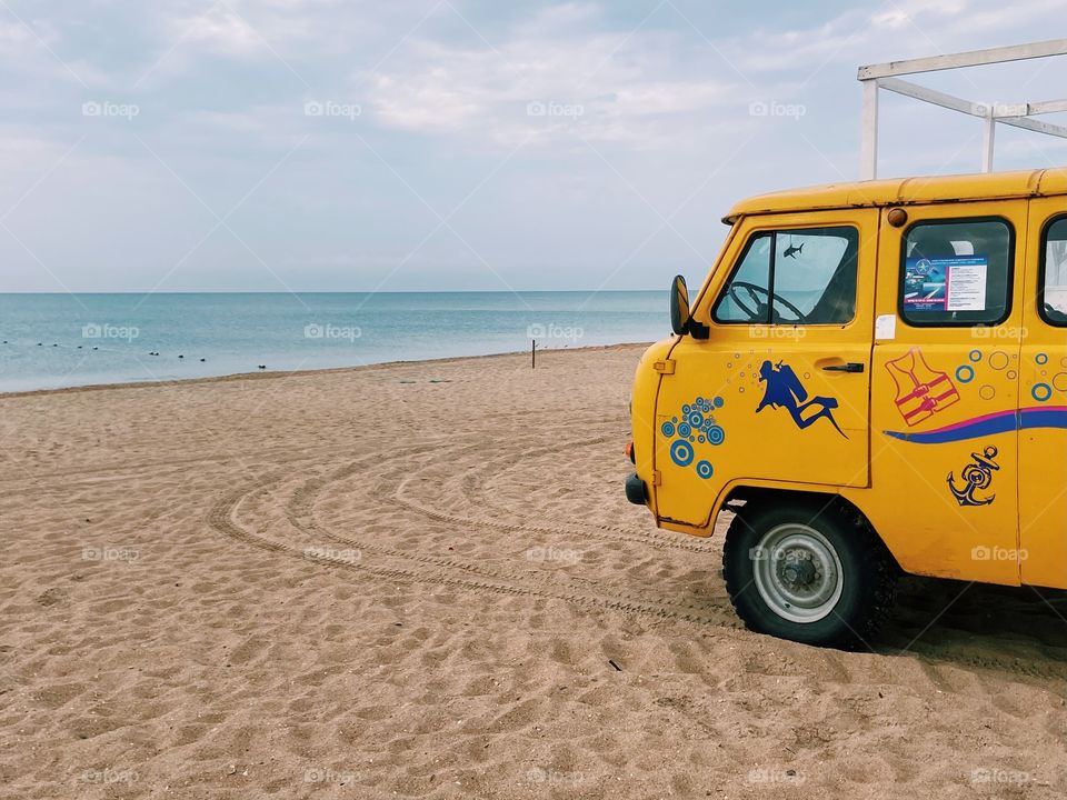 Yellow van on the beach 