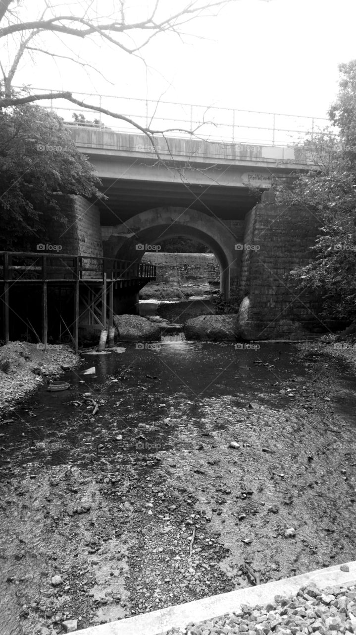 Stream. Bridge by the dam
