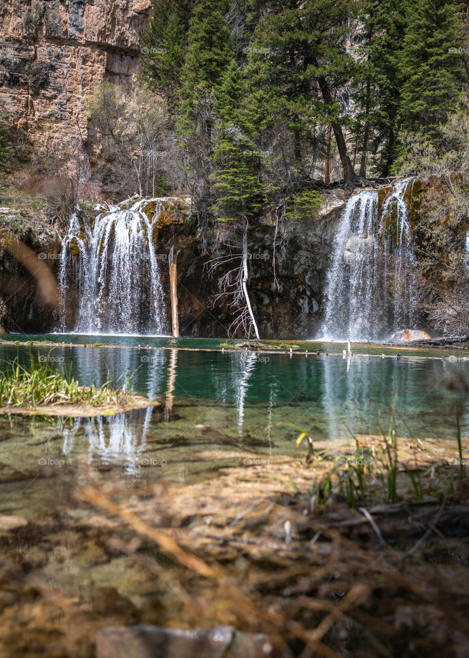 Beautiful crystal clear water flowing from a waterfall into a Colorado lake high in the mountains. 