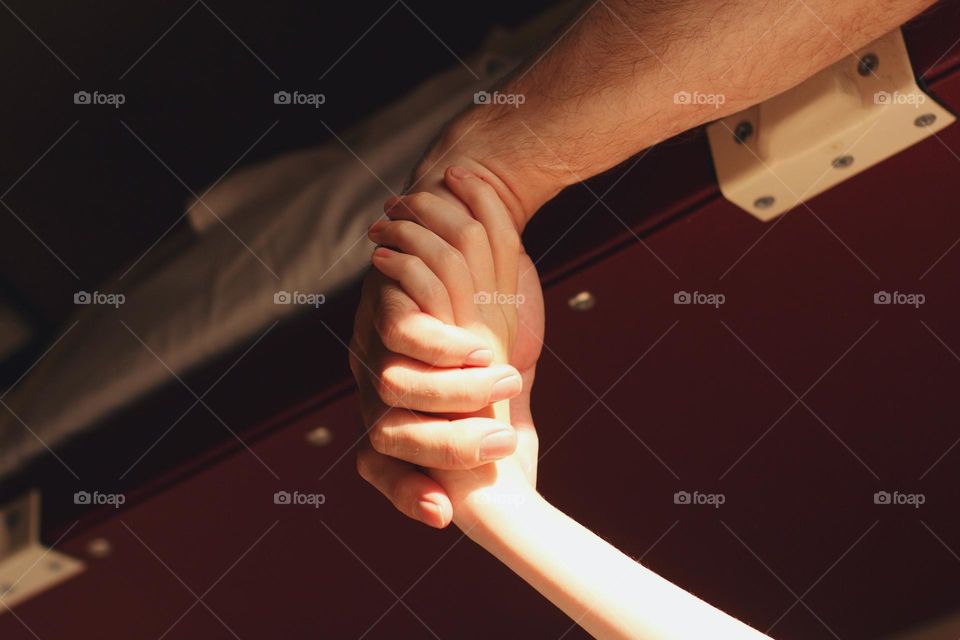 Dad holds his daughter by the hand in the reserved seat car