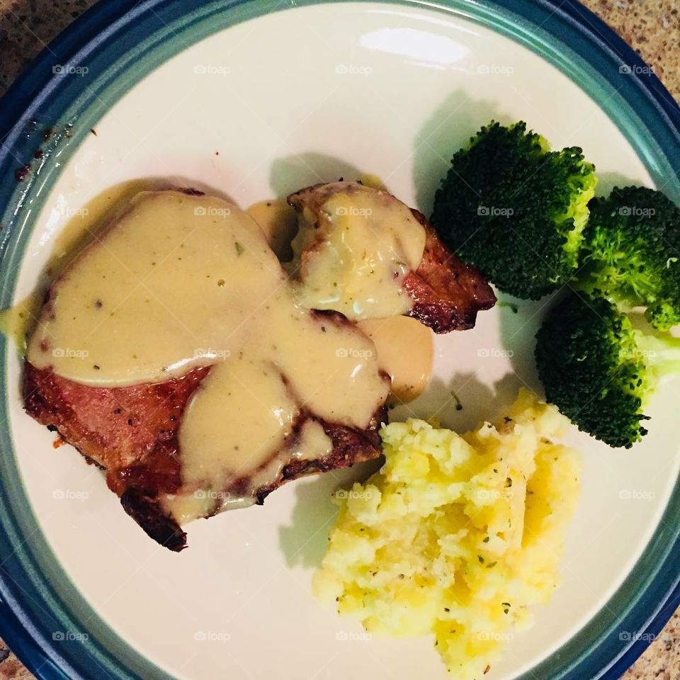 Pork chop with gravy, broccoli and mashed potato