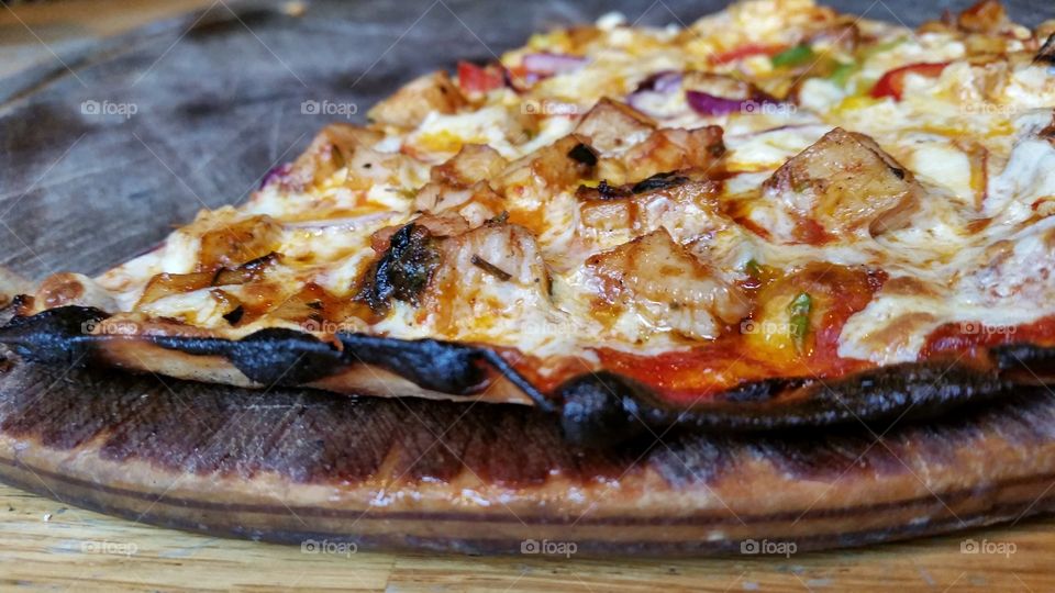 close up to a pizza on a wooden board