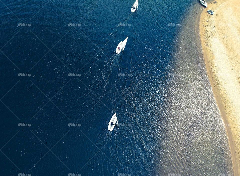 Three Sail boats nearby sea Coast