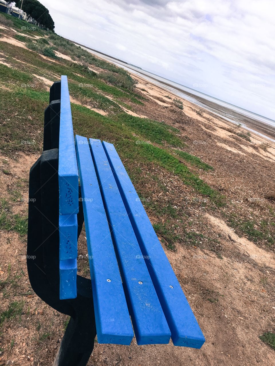 Blue bench perspective one bench on remote beach in south Australia 