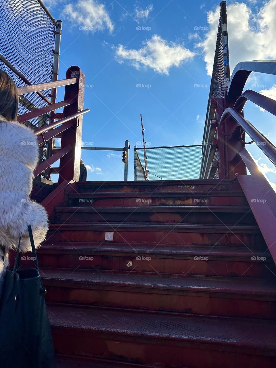 This is the red metal staircase of the “Pulaski Bridge” at “Newtown Creek” in LIC, Queens leading up to the pedestrian lane of the bridge. 2023. Hypnotic Productions