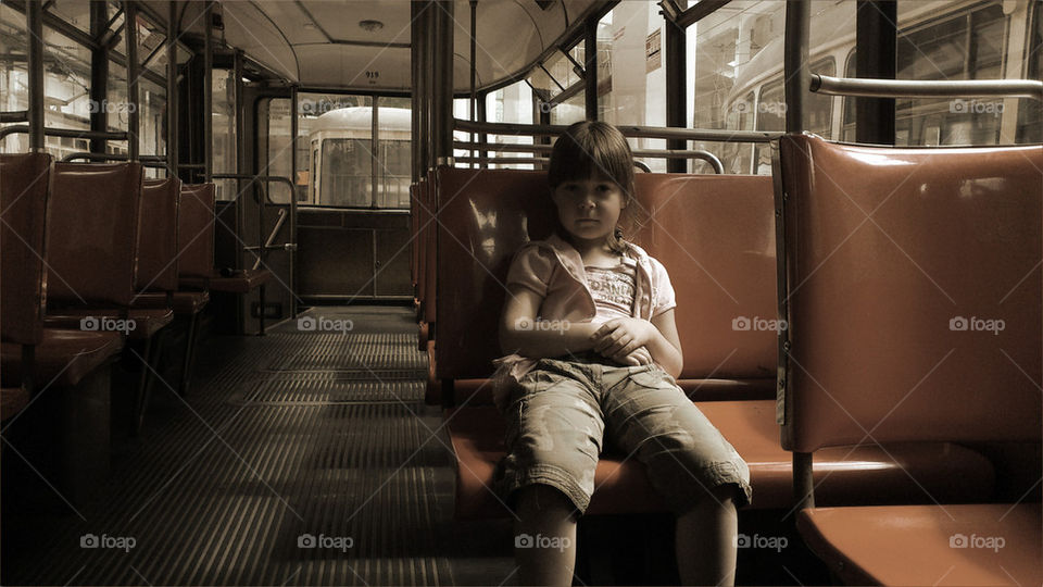 Childhood girl sitting in tram