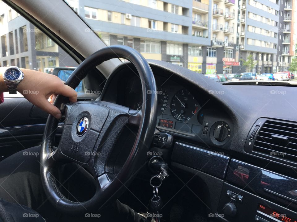 Man driving his BMW through the city