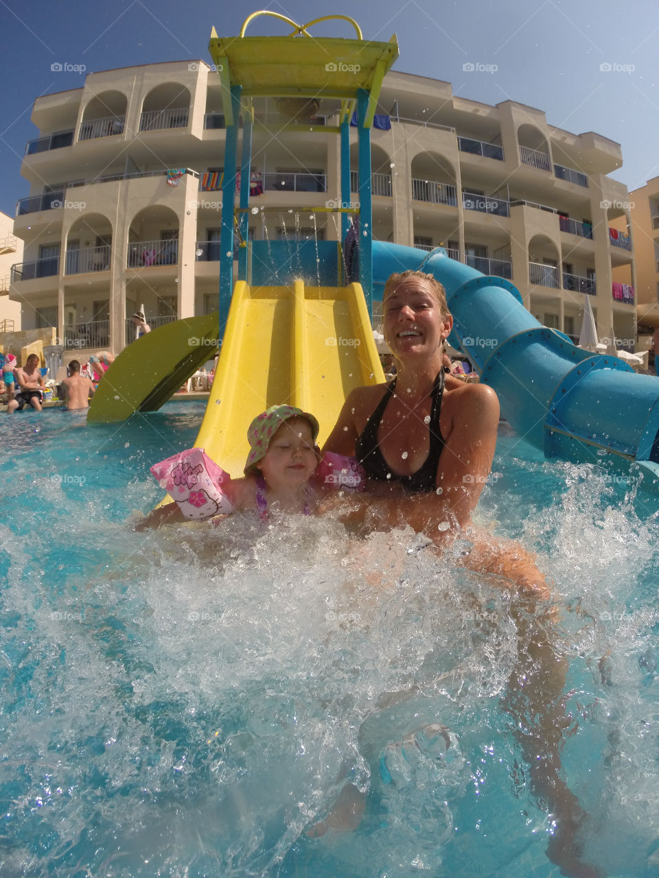 Doughter and mother riding the waterslide at Alcudia Pins on Majorca.