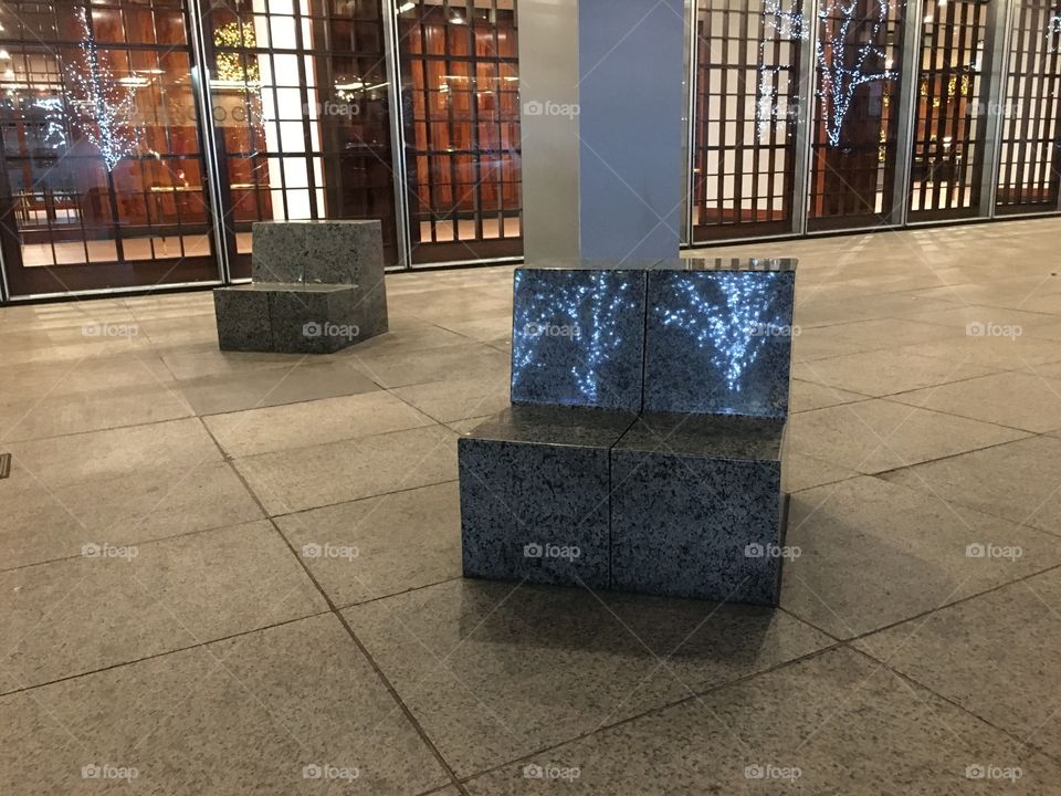 reflection of the  illuminated  trees  on the sidewalk