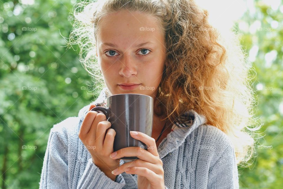 portrait beautiful girl with cup green background