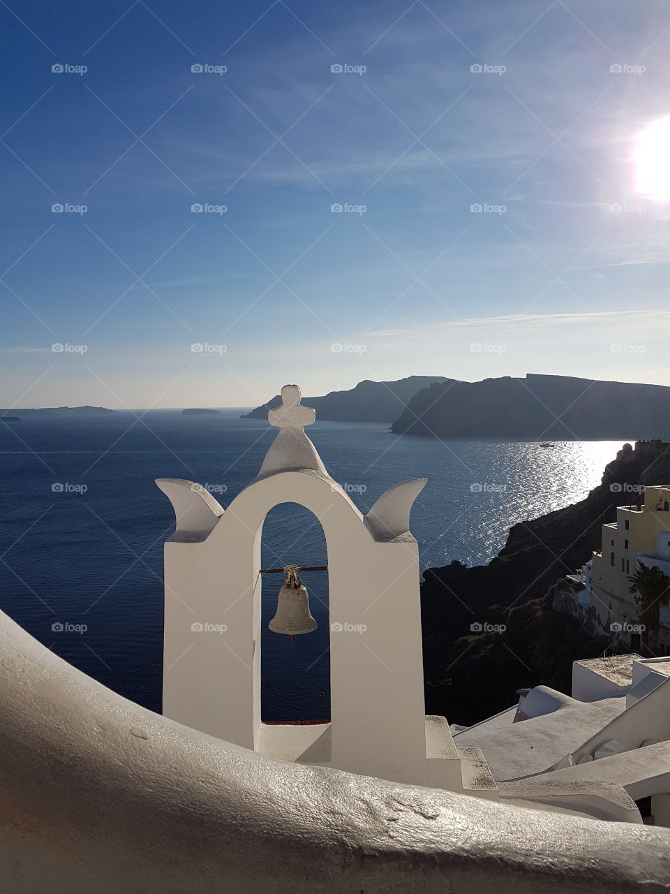 Little greek bell tower illuminated by the spring sunshine of Santorini. Oia, Santorini, Greece